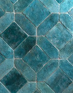 a close up view of a blue tile floor