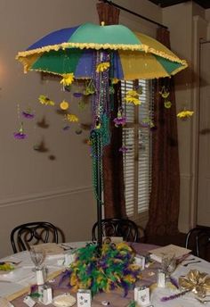 a table with an umbrella and decorations on it