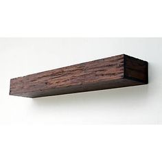 a close up of a wooden shelf on a wall