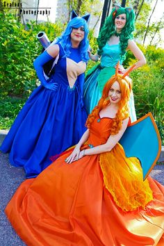 three women dressed in costume posing for the camera