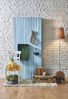 an empty room with a blue door and some books on the floor in front of it