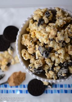 a bowl filled with oreo cookies and popcorn