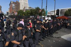 a large group of police officers standing on the street