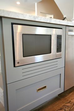 a kitchen with an oven and microwave built into the counter top in front of it