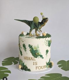 a birthday cake with a dinosaur on top