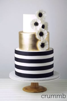 a black and white wedding cake with flowers on top is featured on instagrams