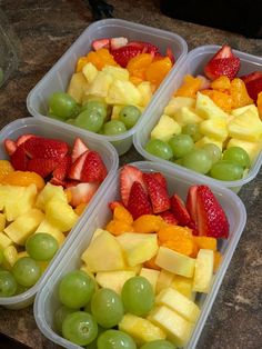 four plastic containers filled with different types of fruit