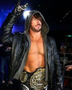 a man wearing a leather jacket and wrestling gloves