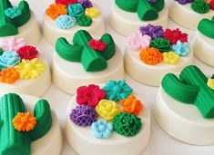 many small cakes decorated with colorful flowers and leaves