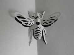 a paper cut out of a bee on the wall