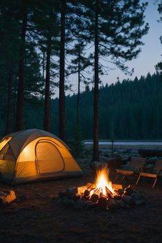 a tent set up next to a campfire in the woods