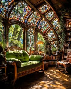 a living room filled with lots of stained glass and bookshelves on the walls