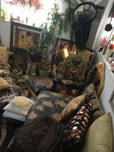 a living room filled with lots of furniture and plants