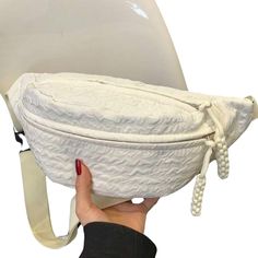 a woman is holding up a white toilet seat with rope on it's side