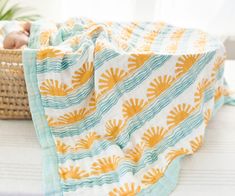 ** personalization will be discontinued until further notice** THE SUN + WAVE PRINT Made from 6 layers of organic bamboo and cotton fibers, this blanket features a vibrant print originally designed using traditional lino block printing. Inspired by sun-soaked beaches and rolling waves, the island surfer vibes of the design have captured hearts in nurseries around the world. Perfect for those who love the ocean, whether you're near or far from it, our Sun + Wave 6 Layer Blanket adds a touch of co Beach Baby Nursery, Surfer Nursery, Beach Nursery Decor, Newborn Hospital Pictures, Boho Ocean, Surfer Vibes, Beach Nursery, Lino Block, Muslin Blanket