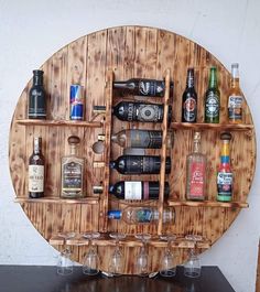 a wooden wine rack filled with bottles and glasses