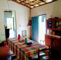 a table with a checkered cloth on it in the middle of a room next to a doorway