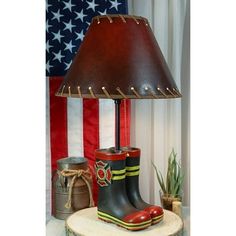 a lamp that is sitting on top of a wooden table next to a potted plant