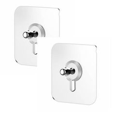 two white square wall plates with handles and knobs on each side, one in the middle