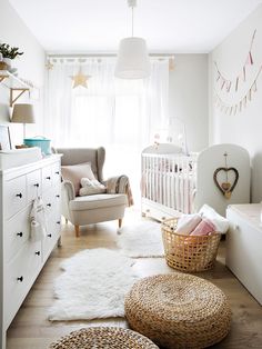 a baby's room is decorated in white and neutrals, with wicker baskets on the floor