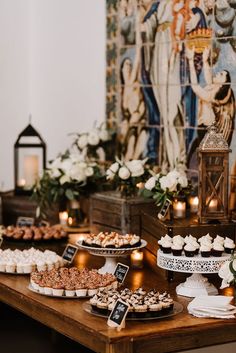 a table topped with lots of desserts and cakes