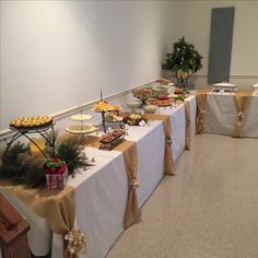 a banquet table with food on it and decorations around the buffet table for guests to eat