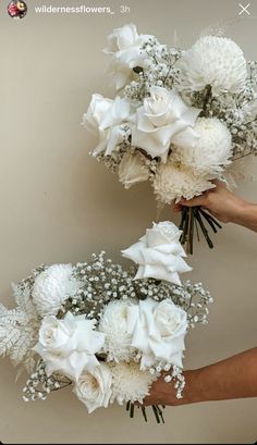 two hands holding bouquets of white flowers