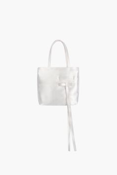 Top handle bag in Pearl Made in a heavyweight satin Welt pocket and mini bow detail Zip closure 7.5" x 6.5" 100% PolyesterImported Size Guide + Shipping Info Monthly payments available at checkout with Affirm. Elegant Bow Tote Shoulder Bag, Elegant Tote Shoulder Bag With Bow, Elegant Formal Bag With Satin Bow, Evening Top Handle Bag With Detachable Bow, Formal Rectangular Bag With Bow, Formal Top Handle Bag With Bow, Chic Formal Bags With Satin Bow, Formal Bow Shoulder Bag, Formal Rectangular Bags With Detachable Bow