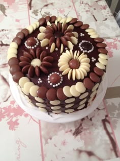 a chocolate cake with white and brown decorations