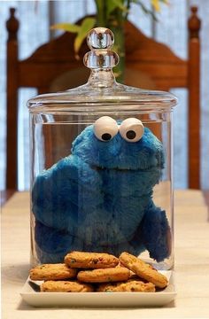 a cookie jar filled with cookies and a blue stuffed animal