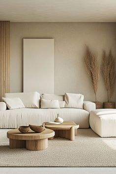 a living room filled with white furniture and pillows