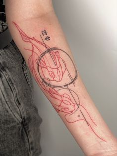 a person with a tattoo on their arm that has red lines and an abstract design