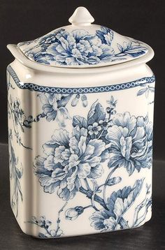 a blue and white flowered canister with lid