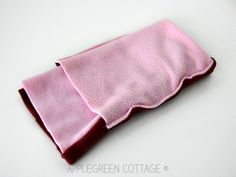 a close up of a pink cloth on a white surface