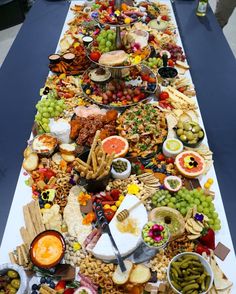 a long table filled with lots of different types of food and snacks on it's sides