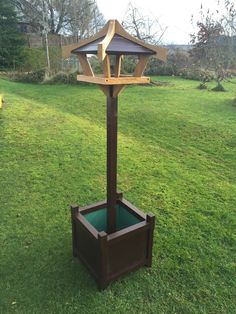 an umbrella stand in the middle of some grass