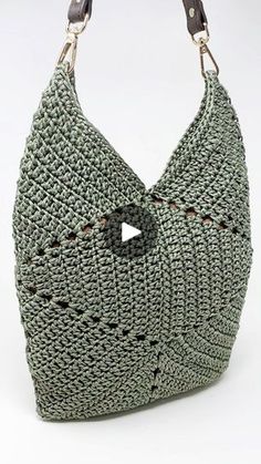 a crocheted bag with a video button on the front and side handles,