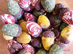 a bowl filled with different colored rocks on top of a wooden table