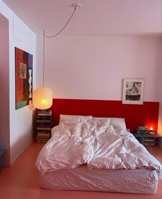 a bedroom with pink walls and white bedding