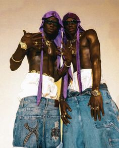 two black men wearing blue jeans and purple ties