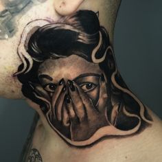 a man's chest with a tattoo of a woman covering his eyes and nose