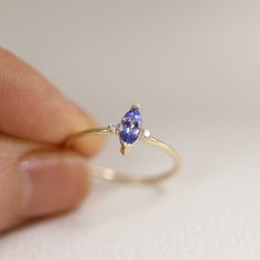 Tanzanite Marquise Double Diamond Ring Band, Engagement Wedding Ring, 10K 14K Solid Gold Ring, Diamond Ring, Stackable Rings, Gifts for Her * Handmade in California Band Thickness: 1.30 mm Stone: 100% Natural Tanzanite, 100% Natural Diamond (0.015 ct x 2 pieces) Metal: Solid 10K, 14K Gold Gold Color: White gold, Rose gold, Yellow gold ≫ Please read our FAQ below for more detail. Double Diamond Ring, Diamond Ring Band, Gold Ring Diamond, Unique Diamond Engagement Rings, Marquise Ring, Flower Engagement Ring, Promise Ring Gift, Double Diamond, Tanzanite Ring