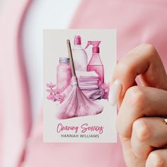 a woman holding up a card with cleaning products on it and a brush in her hand