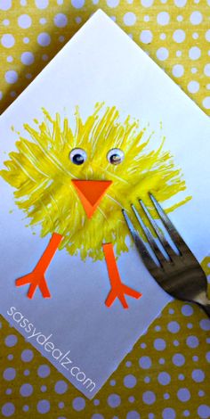 a paper plate with a yellow bird on it and a fork sticking out of it