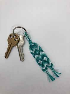 a key chain with two keys attached to it