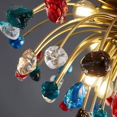 a chandelier with many colorful glass beads hanging from it's arms and sides