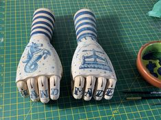 a pair of blue and white gloves sitting on top of a cutting board