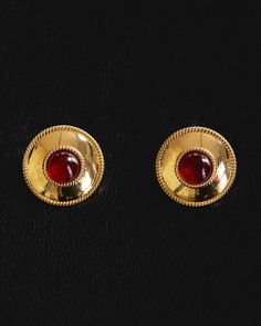 Pair of statement stud earrings featuring a center dark red colored glass stone with a smooth and textured ridged bezel Sold a pair for pierced ears Earring is 25mm x 4mm Pair of earrings weigh 13.75 grams Earrings come with a push back Made from Brass Plated Gold or Silver Posts are made from surgical steel so they are very hypo-allergenic for sensitive ears Earrings are 100% nickel-free and cadmium-free 1 year warranty Packaged in Luv Aj branded gift boxes Part of the Camelia Farhoodi x Luv Aj Red Stone Earrings Gold Studs, Ruby Earrings On Ears, Camelia Farhoodi, Sensitive Ears Earrings, Statement Stud Earrings, Silver Jewlery, Luv Aj, Ear Earrings, Shiraz