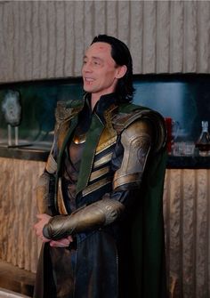 a man dressed up as loki in front of a bar