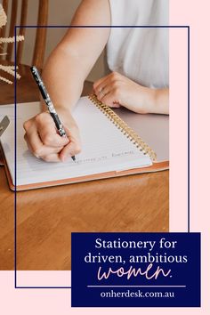 a woman sitting at a table writing in a notebook with the words stationery for driven, ambitious women